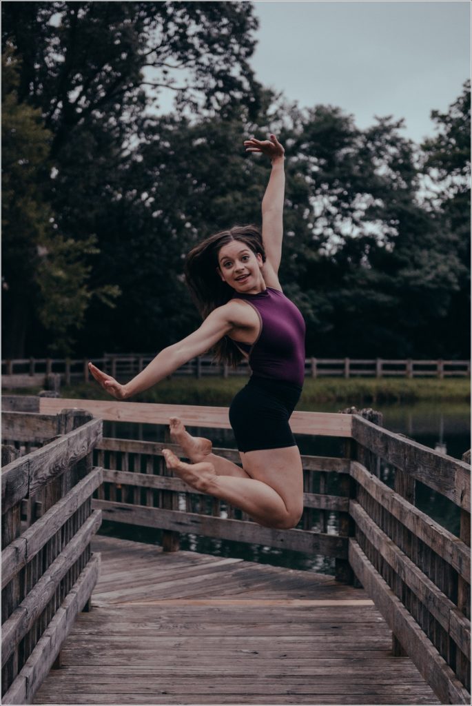 dc dancer in purple leotard and black shorts dances on wooden foot bridge in Gaithersburg Maryland