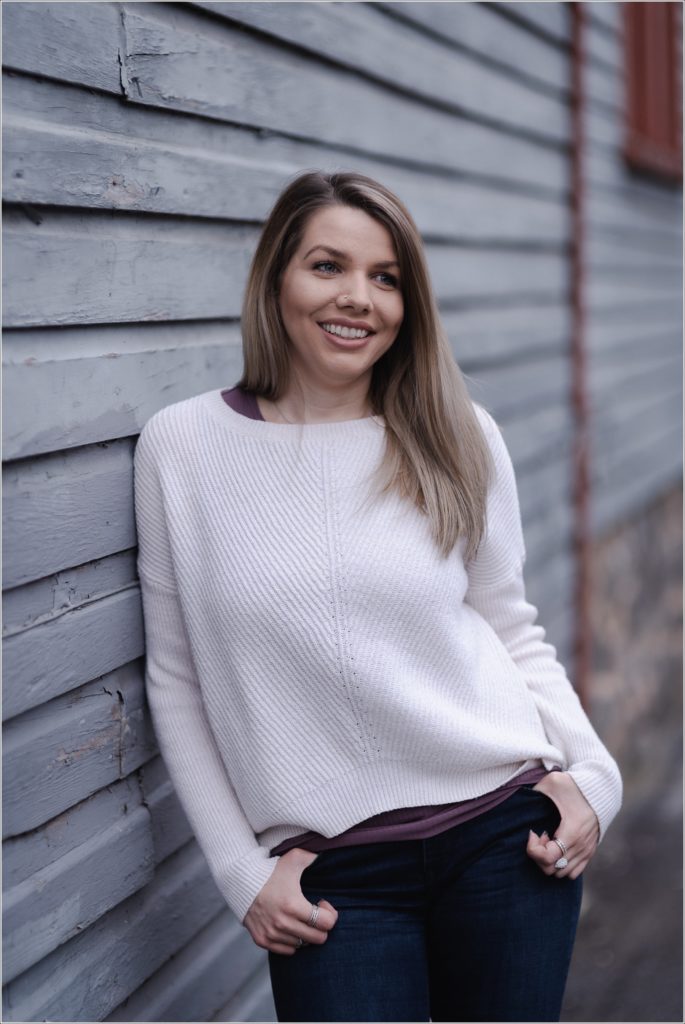 arbonne consultant poses against grey wooden wall for personal branding photography