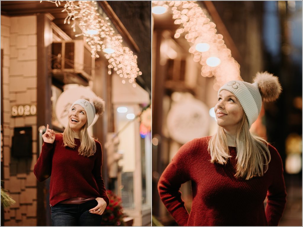 arbonne consultant poses in white arbonne hat and red sweater against christmas lights for personal branding photography