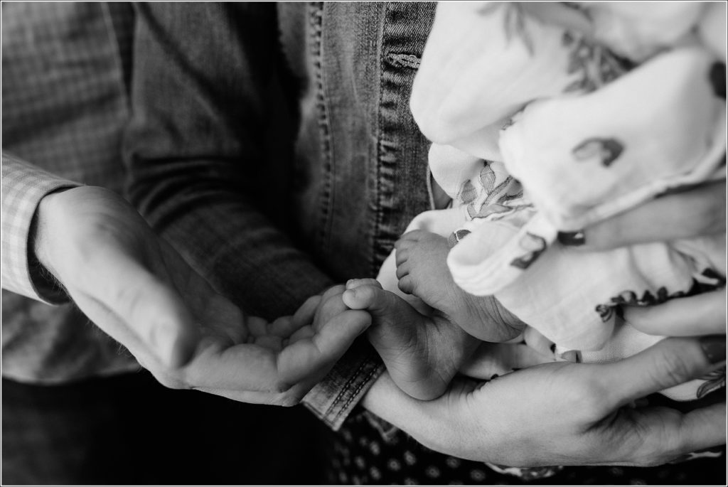 black and white image of newborn baby toes