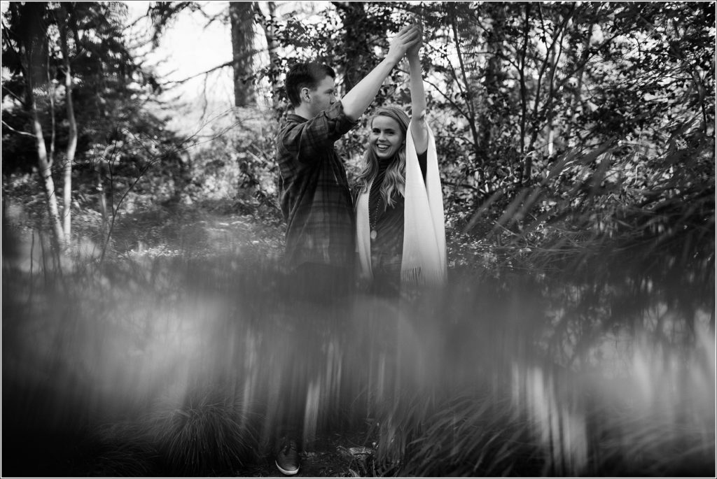 black and white image of couple holding hands in the asian garden in national arboretum engagement photos