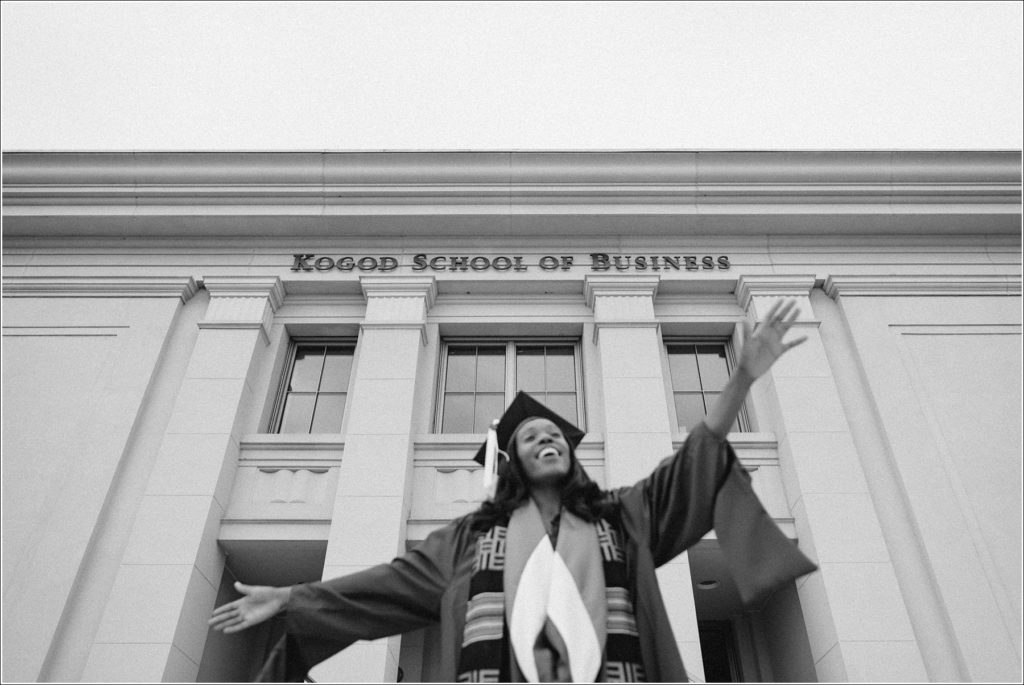 black and white graduation photos in front of kogod school of business in cap and gown