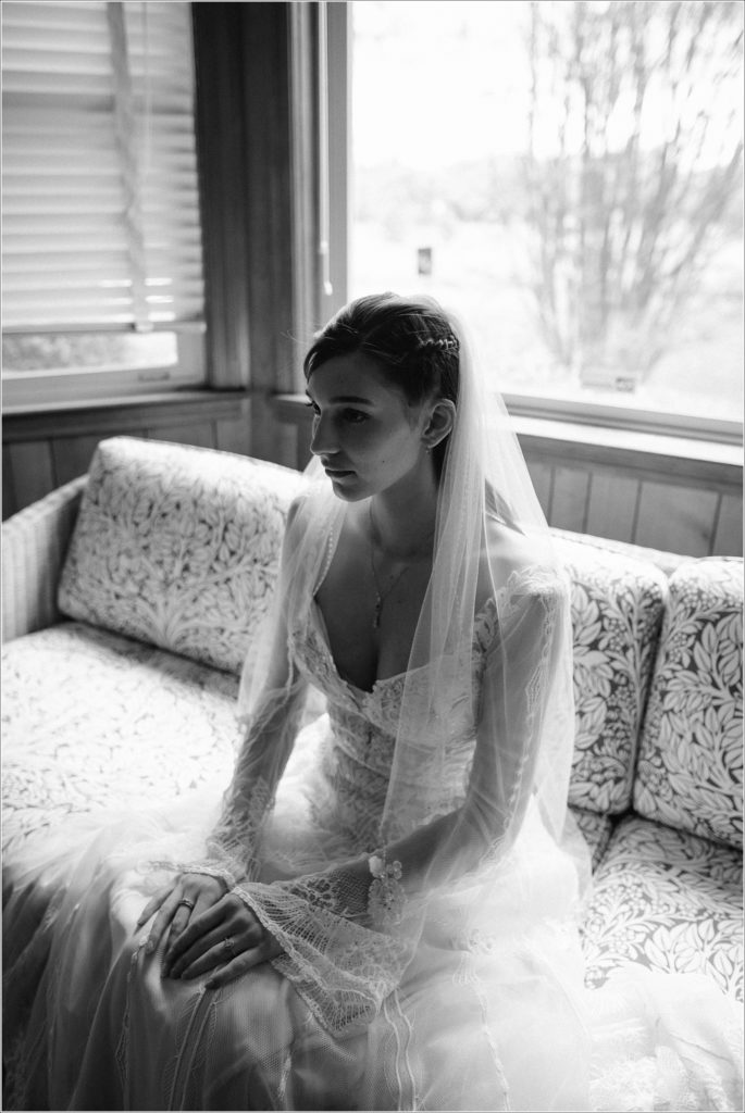 black and white image of bride sitting on couch for her northeast tennessee wedding