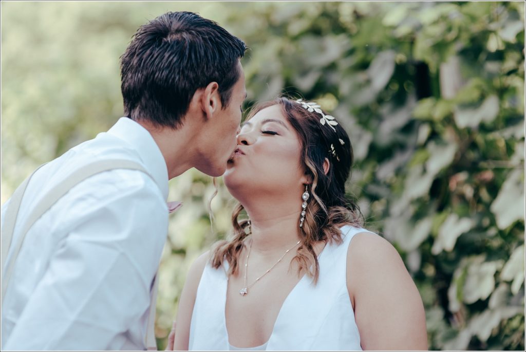 bride and groom walk in Orchard House vineyard
