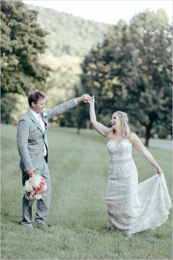 bride and groom pose with florals at vineyard