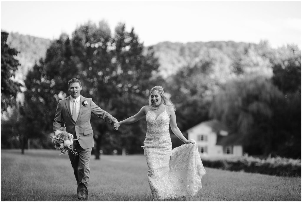 bride and groom pose with florals at vineyard