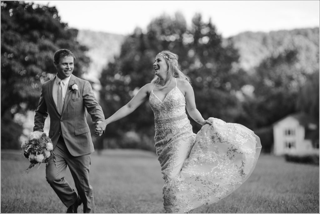 bride and groom pose with florals at vineyard
