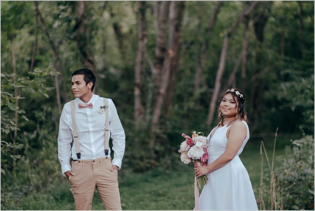 bride and groom walk in Orchard House vineyard