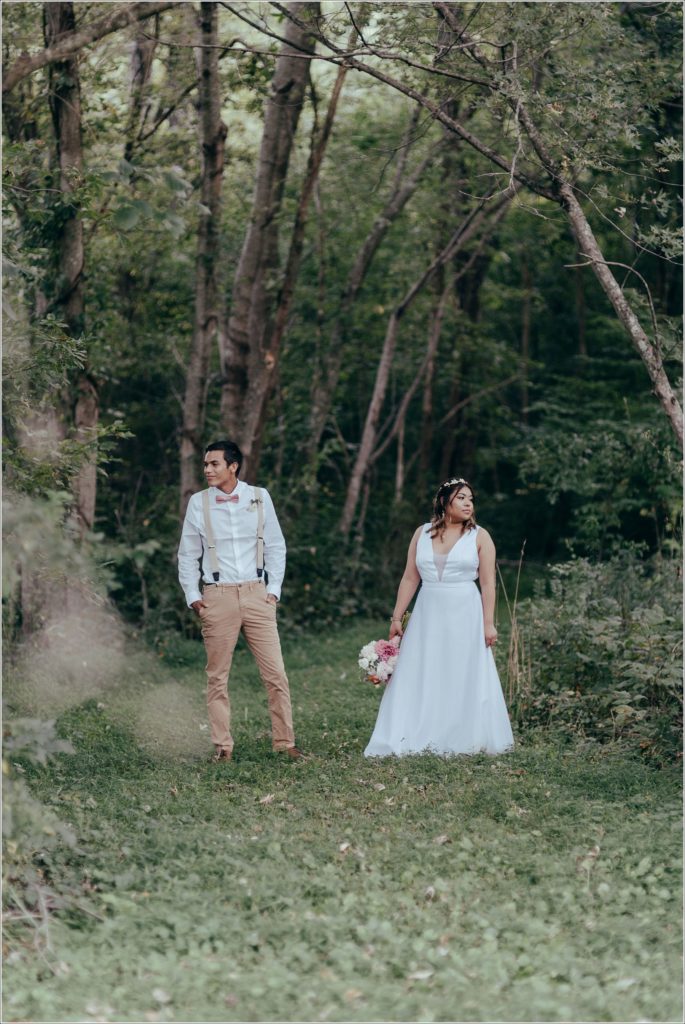 bride and groom walk in Orchard House vineyard