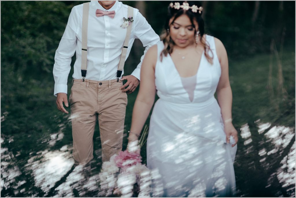 bride and groom walk in Orchard House vineyard