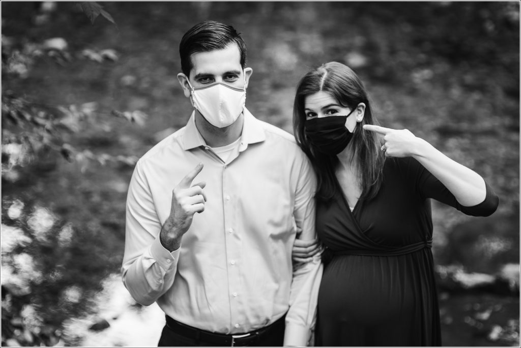 couple poses at sligo creek trail in burgundy maternity dress black and white