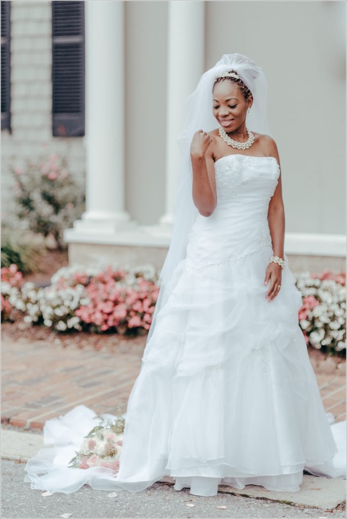 bride poses in front of kings contrivance restaurant