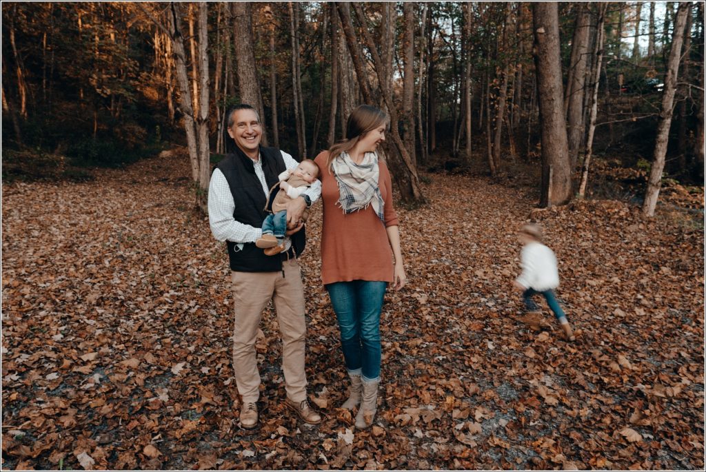 mom and dad embrace kids in fall at abingdon vineyards