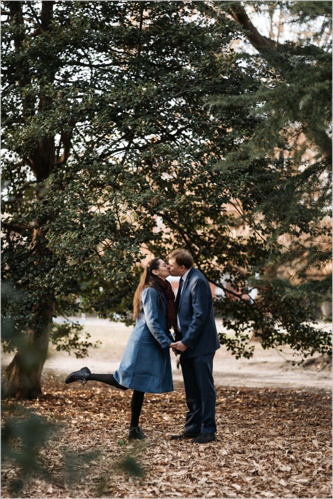 couple poses for DC elopement with green backdrop in Lincoln Park