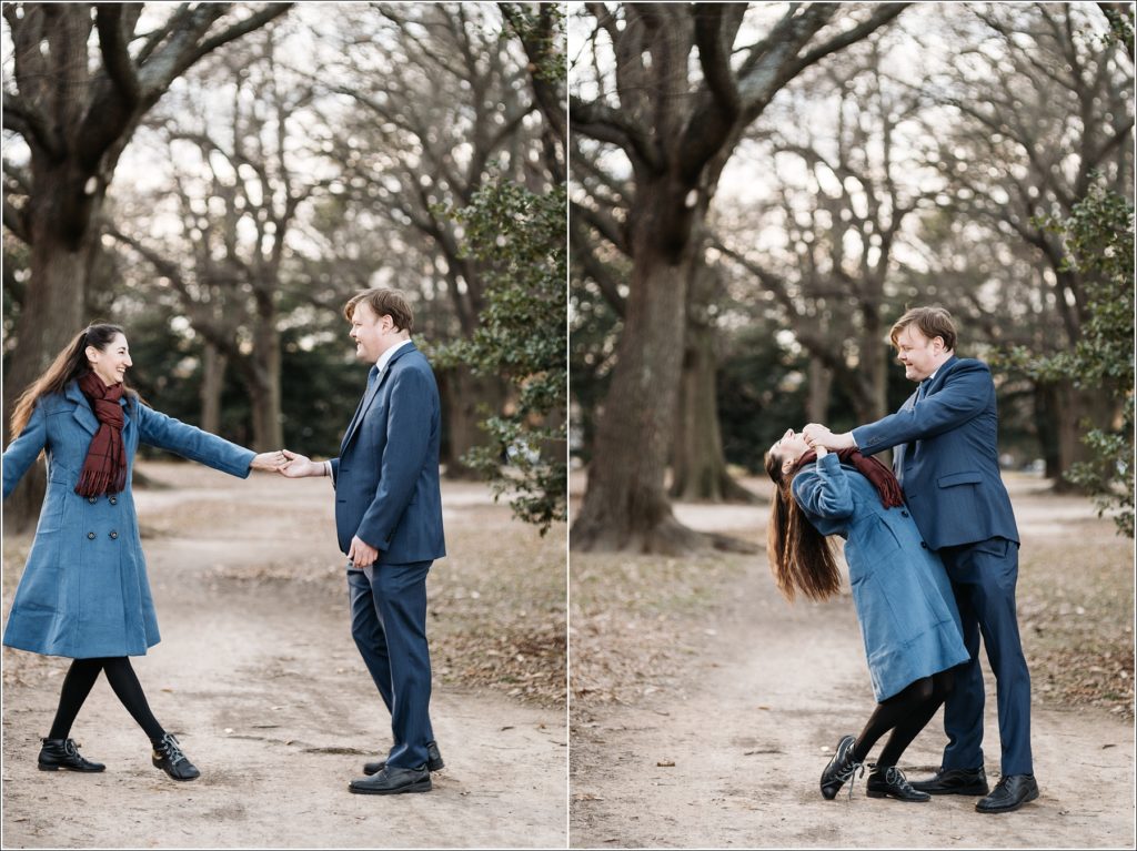 couple dances on walking path in DC wearing blue winter outfits