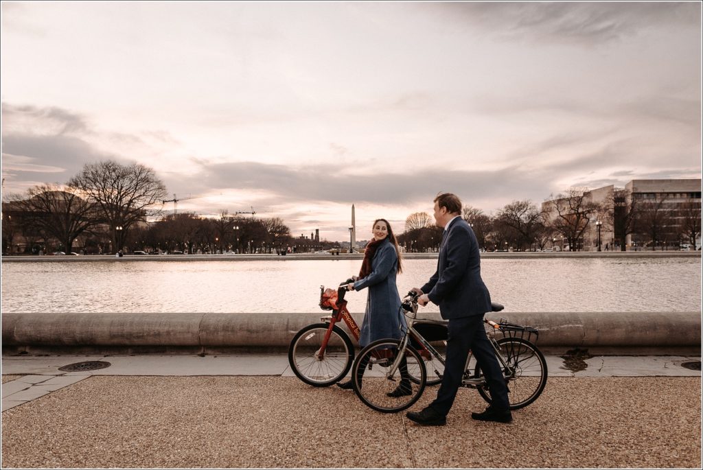 couple rides bikes in front of US Capitol for DC elopement