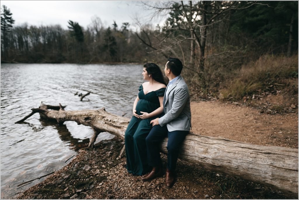 couple poses for maternity photos at Loch Raven Resevoir