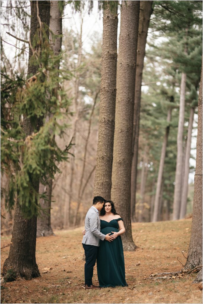 couple poses for maternity photos at Loch Raven Resevoir