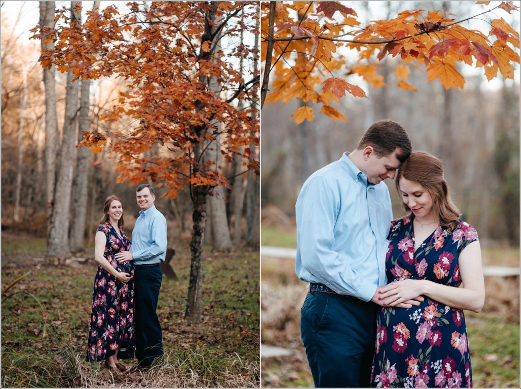 pregnant woman and man hug in Patuxent River State Park underneath orange leaves