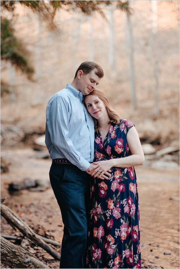 pregnant woman and man hug in Patuxent River State Park