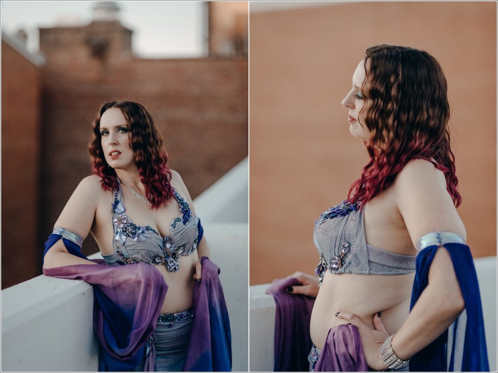 belly dancer photoshoot in blue and purple costume with red brick backdrop