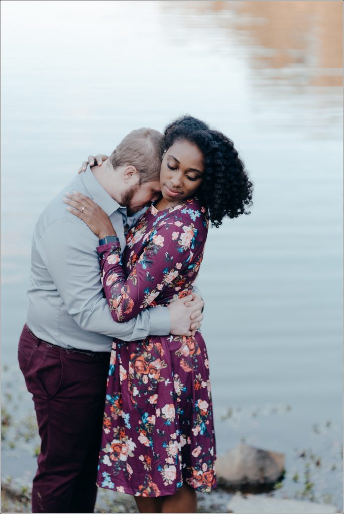 man and woman in floral dress embrace at allen pond park