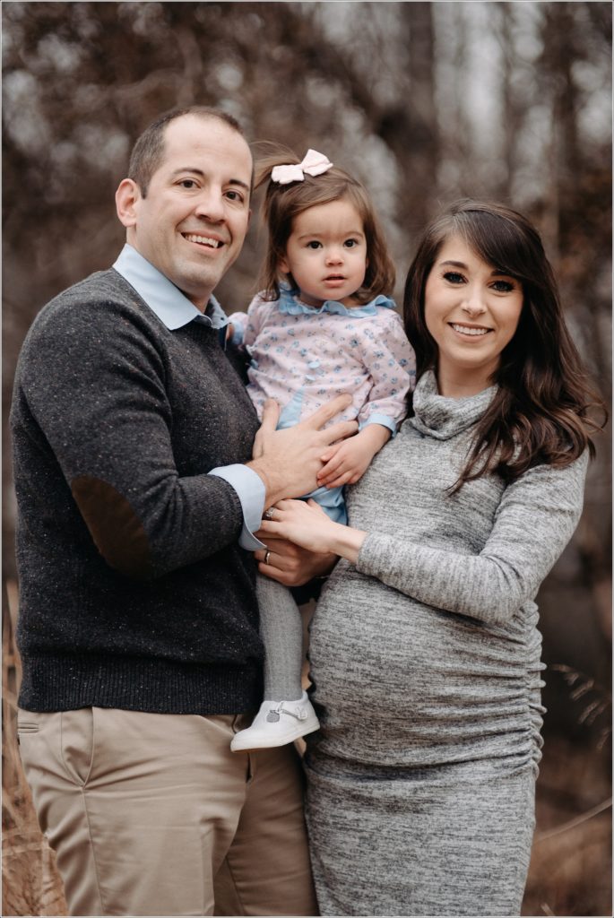 family poses in muted colors in silver spring for family photos
