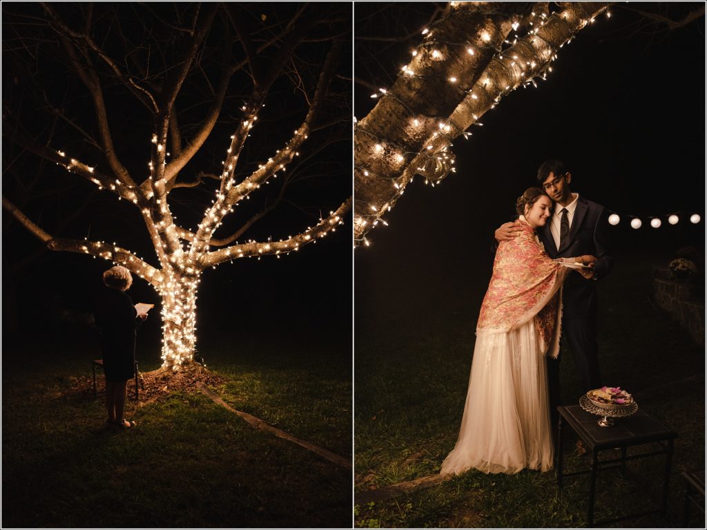 bride and groom embrace in the light of a decorated tree at wedding reception in southern maryland
