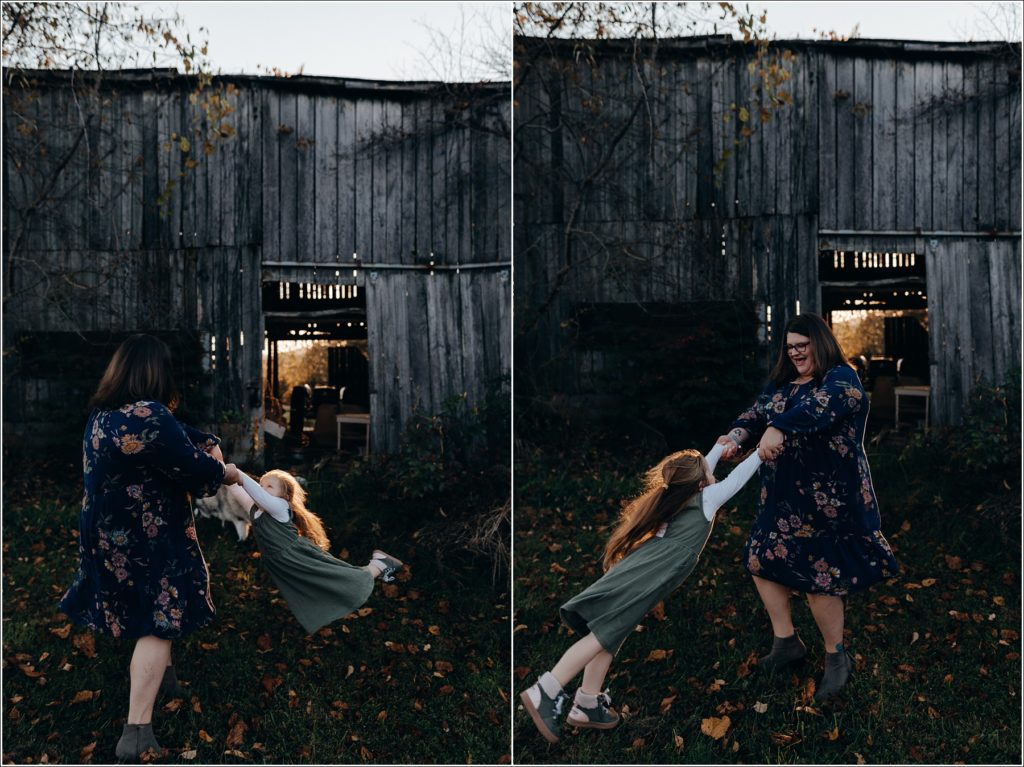 little girl is swung by mother in front of old barn in swva photography in meadowview va
