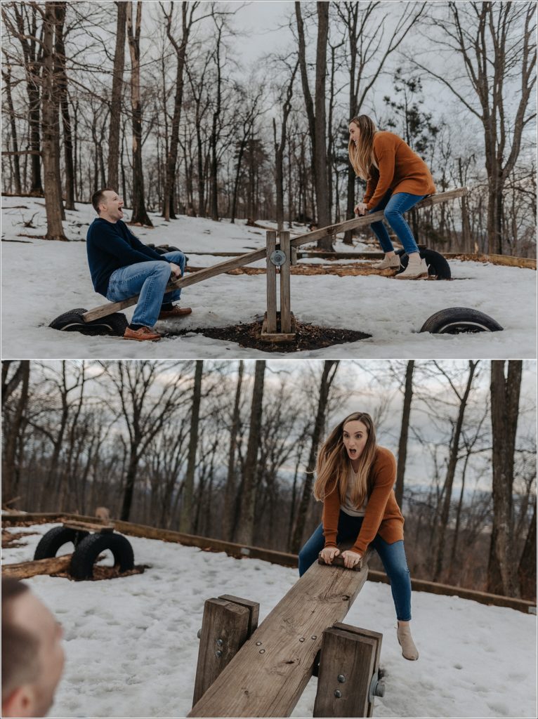 a couple wearing orange and blue play on a seesaw at the middletown overlook for firefighter engagement photos