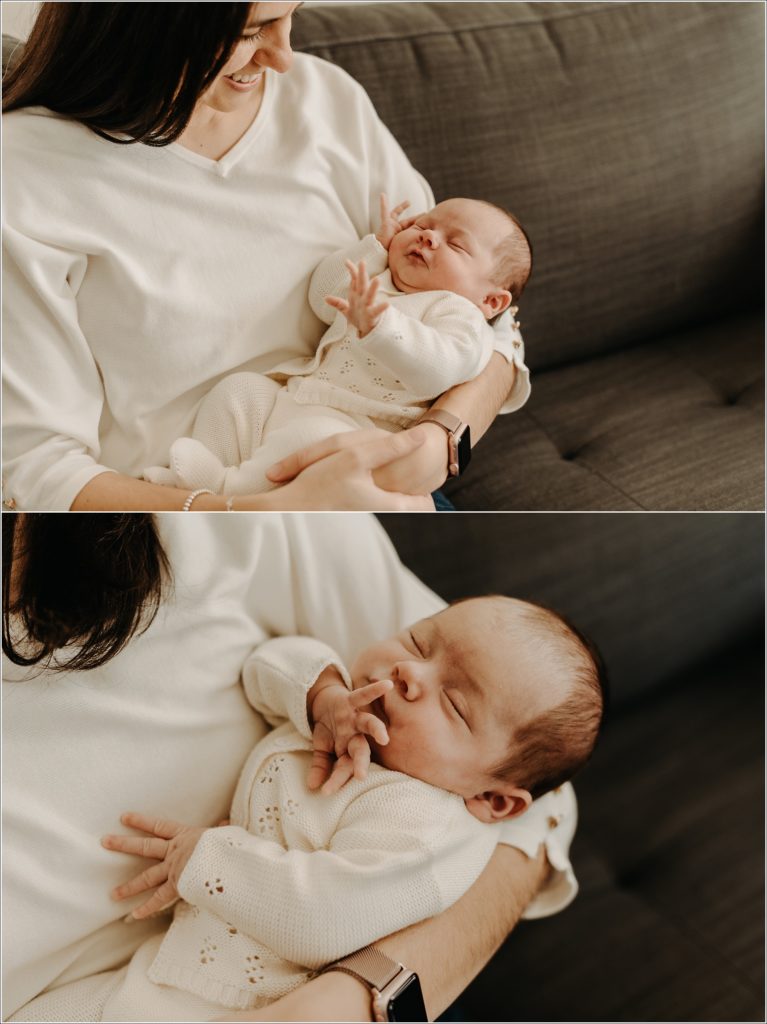 new mother holds newborn for in home newborn photography wearing cream sweater