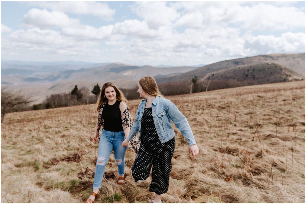 two women pose on roan mountain for surprise proposal engagement photos