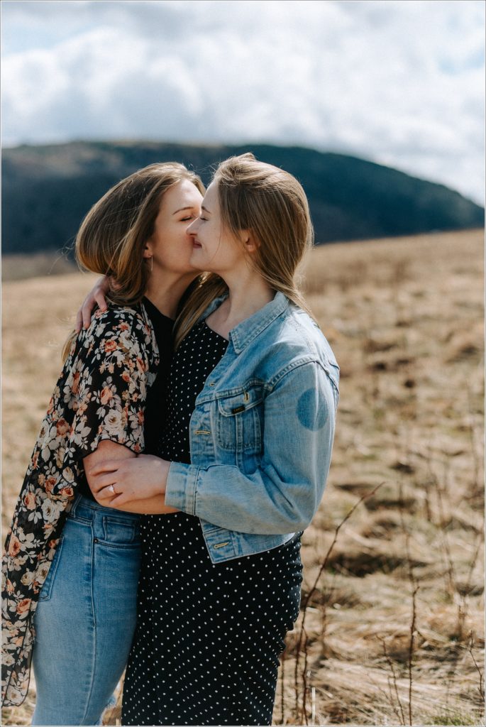two women kiss on roan mountain in surprise proposal engagement photos