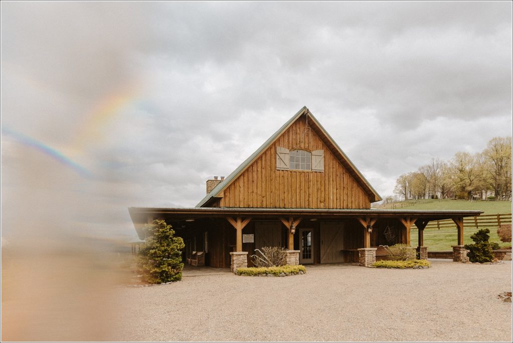 the barns at chip ridge on a cloudy day with a rainbow prism