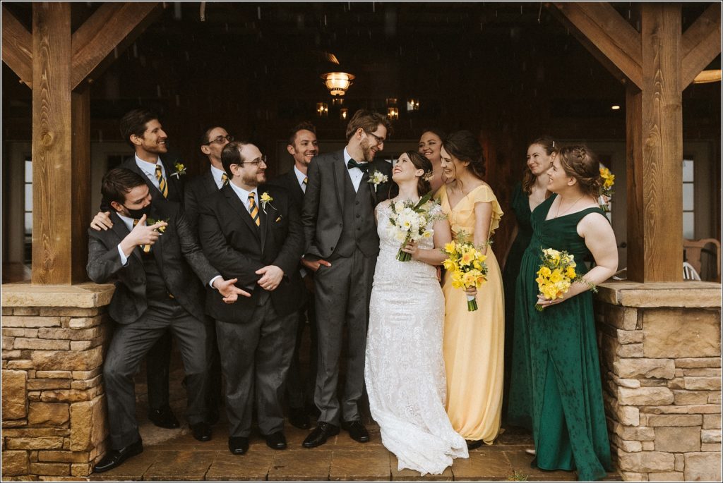 bridal party looks in and cheers bride and groom on at the barns at chip ridge