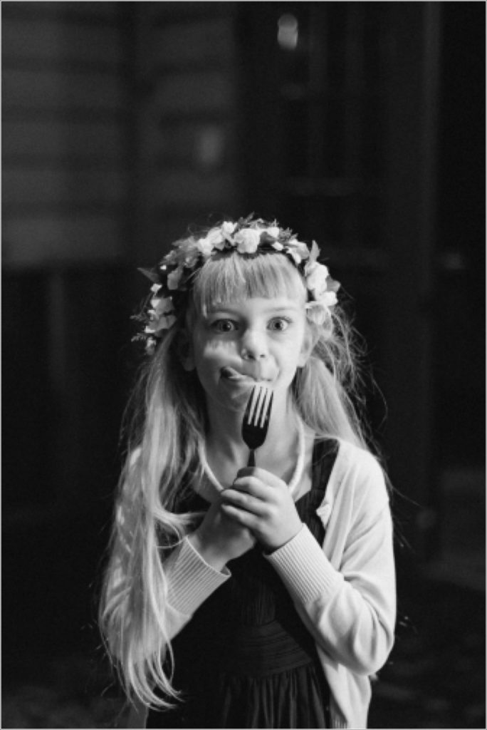 flower girl holds a fork with floral crown at the barns at chip ridge