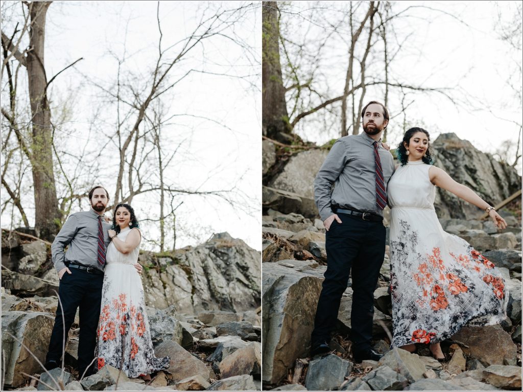couples poses at great falls virginia and woman tosses white dress with red and black flowers for couples photoshoot