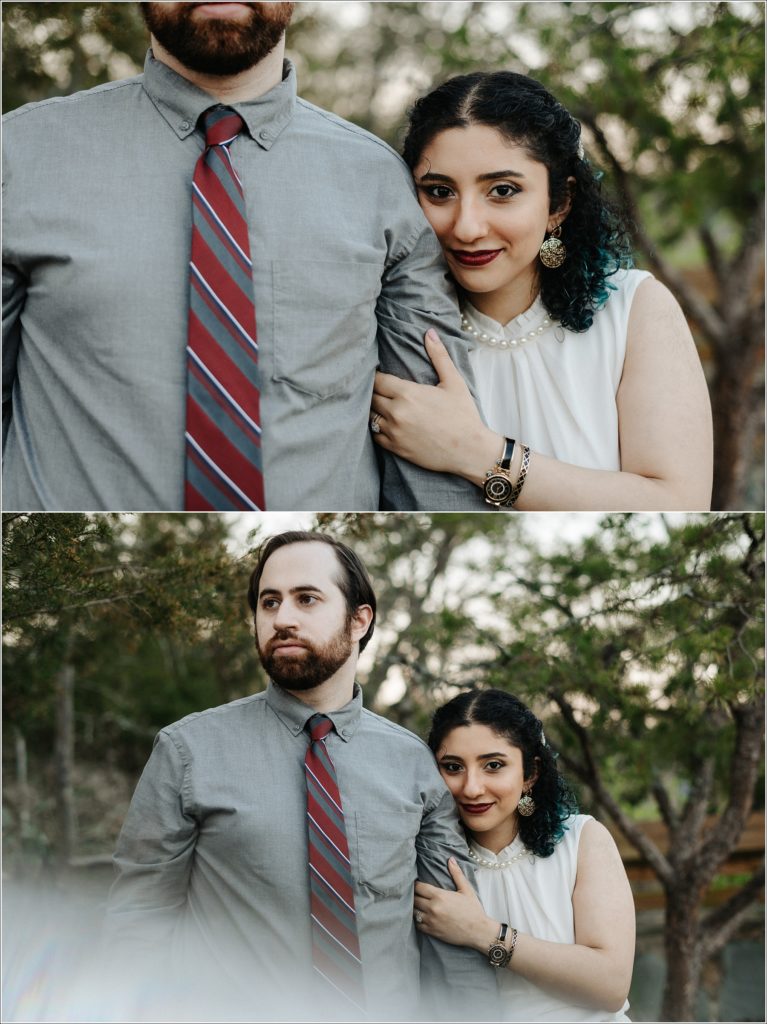 couple snuggles up at sunset with grey button and red tie and white dress with pearls at great falls state park for photoshoot