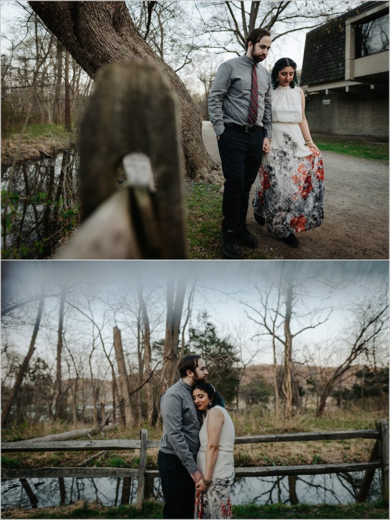 couple snuggles up at sunset with grey button and red tie and white dress with pearls at great falls state park for photoshoot