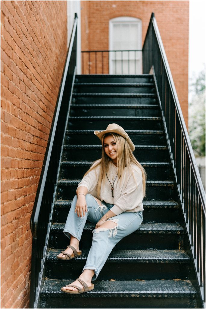 staircase ideas for senior pics girl in cowboy hat in downtown frederick