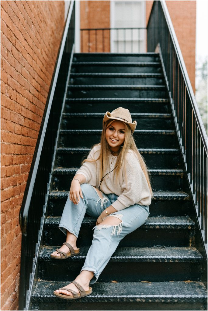 staircase ideas for senior pics girl in cowboy hat in downtown frederick