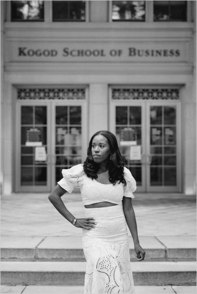 black and white graduation photos in front of kogod school of business in white dress