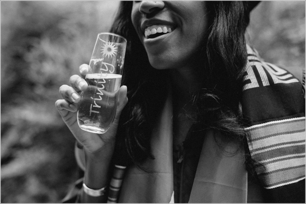 graduate of kogod business school holds glass with champagne black and white photo