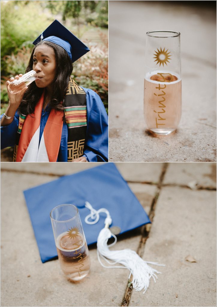 kogod school of business grad in blue cap and gown poses in front of greenery and sips champagne