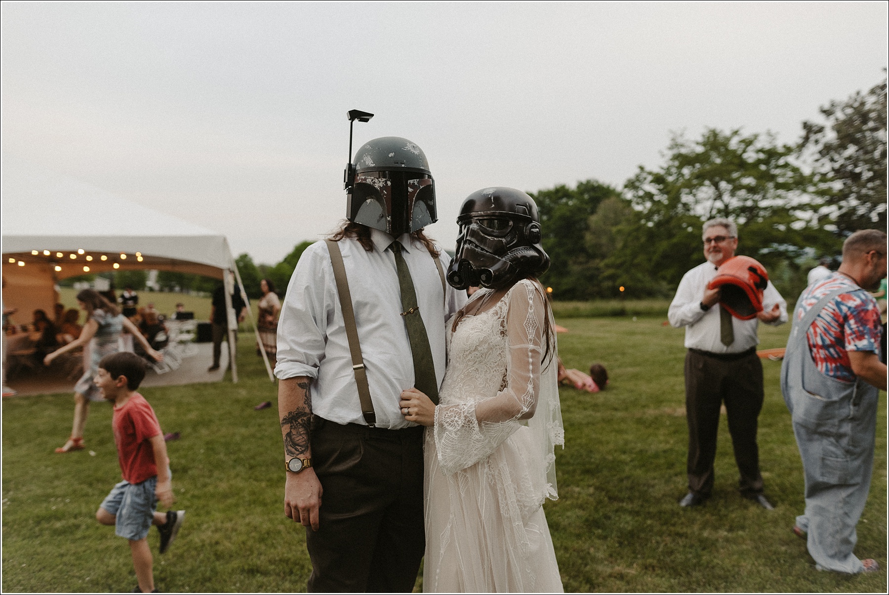 couple poses with star wars helmets in tennessee backyard wedding