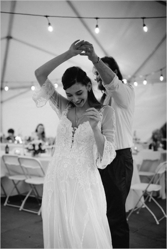black and white image of couple's first dance in a tent