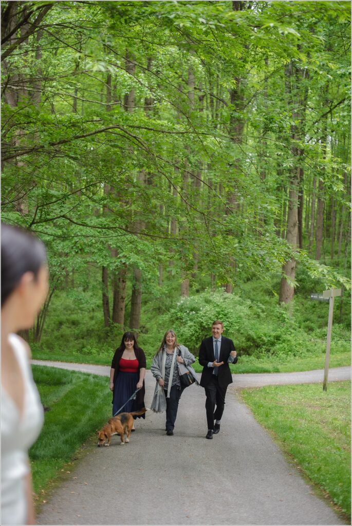 people walk with a poop bag in hand in a park